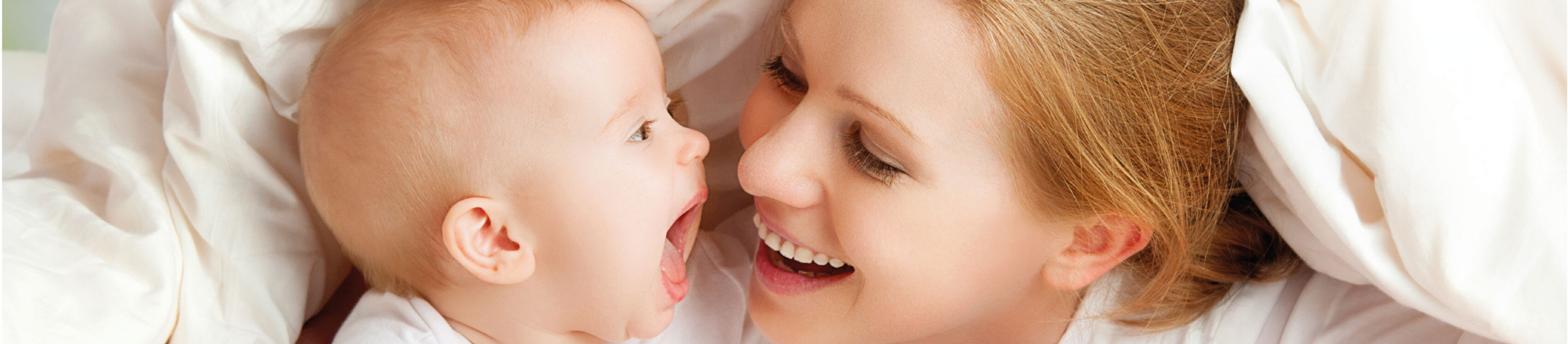 woman and baby laughing